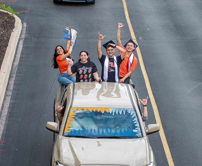 Students celebrating UTSA Commencement Drive